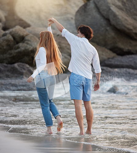 Image of Love, dance and happy with couple at beach for romance, relax and vacation trip. Travel, sweet and cute relationship with man and woman holding hands on date for summer break, trust and bonding