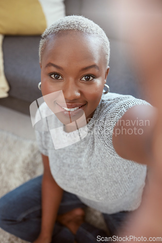 Image of Portrait, black woman and selfie in home, smile and living room for social media, relax and live streaming. Face of happy female influencer, profile picture and video call in house, lounge or vlogger