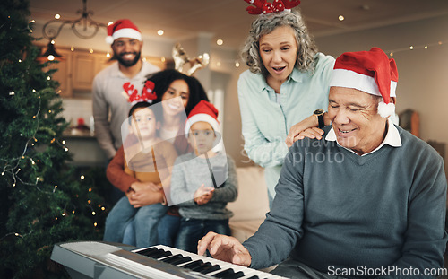 Image of Family, christmas and senior man with piano in a living room for celebration, song and bond in their home. Music, instrument and retired pianist performing for kids and parents in festive celebration