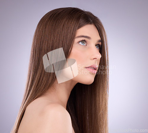 Image of Face, beauty and hair care of a woman in studio isolated on a gray background. Makeup cosmetics, thinking and young female model with salon treatment for healthy keratin, balayage or hairstyle growth