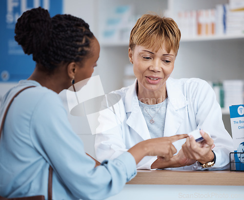 Image of Healthcare, label information and black woman with pharmacist at counter for advice on safe prescription drugs. Health, pharmaceutical info and patient consulting medical professional at pharmacy.
