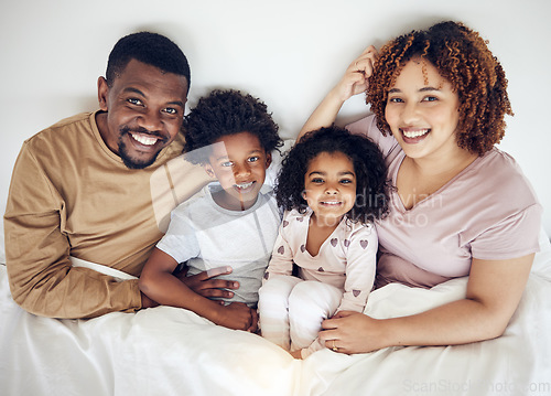 Image of Family, bed and happy portrait of a mother, father and children in a bedroom in the morning. Home, happiness and smile of a mom, kids and papa together with bonding, parent care and love in a house