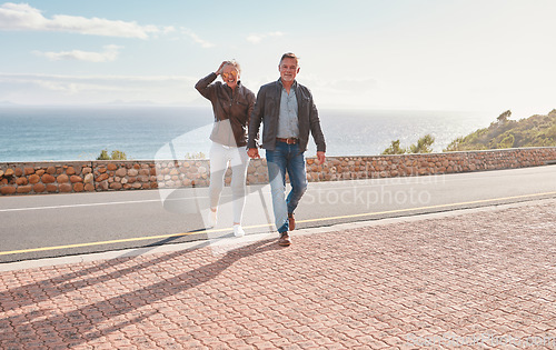 Image of Travel, road and senior couple walking enjoy holiday, adventure and vacation holding hands on mountain. Retirement, love and happy old man and woman for bonding, quality time and relax together