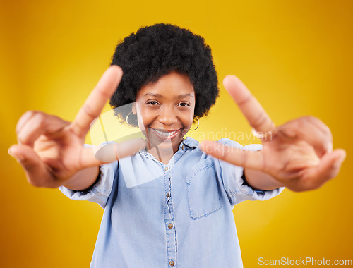 Image of Happy, peace sign and portrait of a black woman in studio with a positive and goofy mindset. Happiness, smile and African female model with an afro posing with chill hand gesture by yellow background