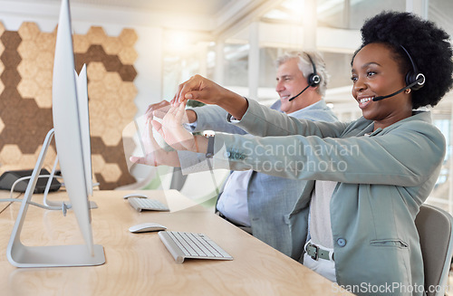 Image of Call center, black woman and employees stretching, customer service and happiness in office. African American female agent, wellness and coworkers stretch hands, smile and telemarketing in workplace