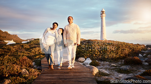 Image of Happy, beach and girl with grandparents on boardwalk for travel vacation, bonding or sunset. Lighthouse, summer break and commitment with child and senior couple walking for support, positive or care