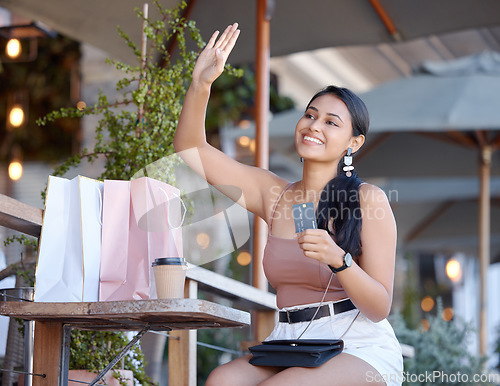 Image of Credit card, shopping and a woman with coffee at a cafe, calling and customer at a restaurant. Payment, happy and a girl waving for attention at a diner to pay, buy take away and spend on lunch