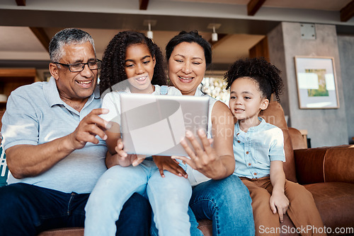 Image of Relax, family and girls with tablet on sofa in home living room for social media or funny video streaming. Technology, care or happy grandfather, grandma and kids laughing or bonding with touchscreen