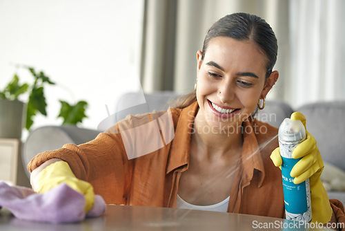 Image of Woman, spray bottle or cloth wipe in spring cleaning, housekeeping or home maintenance in healthcare wellness. Smile, happy or maid cleaner and furniture product for table dust in hospitality service