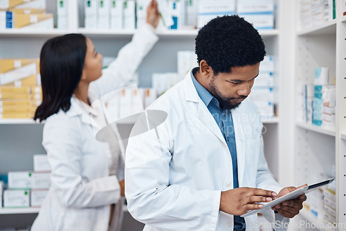 Image of Pharmacy tablet, product inventory or black man doing stock take in retail drugs store or healthcare pharmaceutical shop. Clinic people, check pills shelf or medical pharmacist with digital checklist