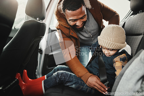 Image of Father help child fasten seat belt leaving for vacation, trip or holiday in a car before travel together. Transport, transportation and dad or parent with kid in a vehicle for a getaway