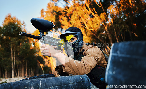 Image of Paintball man with gun shooting target in forest battlefield, competition or games for fun adventure training. Aiming skill of male player or sports person in military focus or woods survival mission