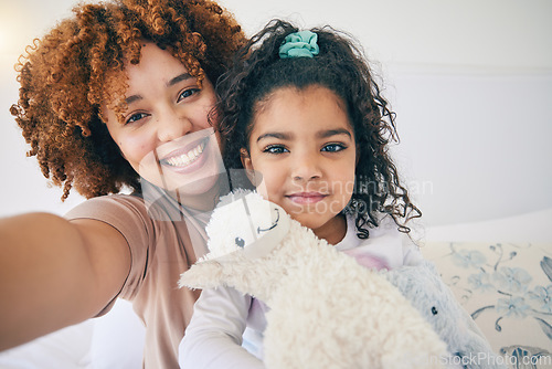 Image of Mother, home and young girl selfie on a bed in the morning with toy in a family bedroom. House, smile and happy mom with a child taking a picture for social media with mama love and care for her kid