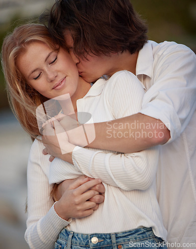 Image of Love, kiss and couple hug, quality time and celebration with smile, relationship and affection. Romance, man or woman embrace, bonding or loving with joy, anniversary or romantic outdoor and cheerful