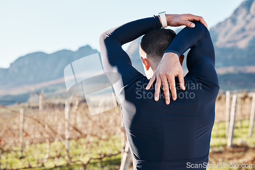 Image of Man, stretching before run and fitness outdoor, back view with hiking or running in countryside, exercise and warm up. Arms, muscle and strong male runner, start with race for marathon or trekking