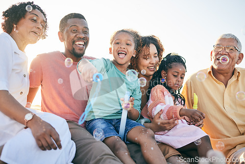 Image of Relax, happy and bubbles with black family in outdoors for bonding, summer break and generations. Happiness, playful and grandparents with parents and children for free time, weekend or youth