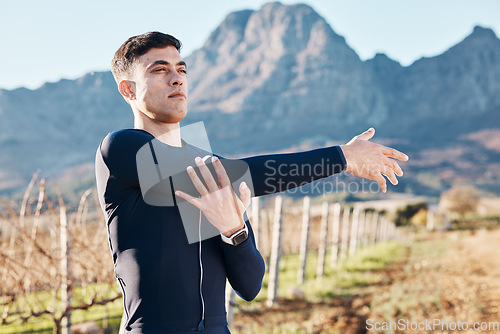 Image of Man, stretching arms with run and fitness outdoor, nature view with hiking or running in countryside, exercise and warm up. Serious, muscle and strong male runner, start with marathon or trekking