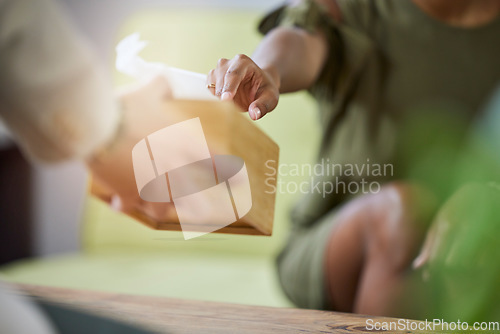 Image of Therapist hand, tissue box and black woman at therapy consultation for grief and depression help. Mental support, healthcare appointment and sad female with trust and blurred background in a office