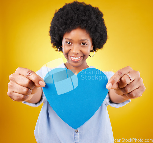 Image of Paper, heart and portrait of black woman in studio for romance, positive and emotion. Happiness, love and giving with female isolated on yellow background for date, feelings and affectionate