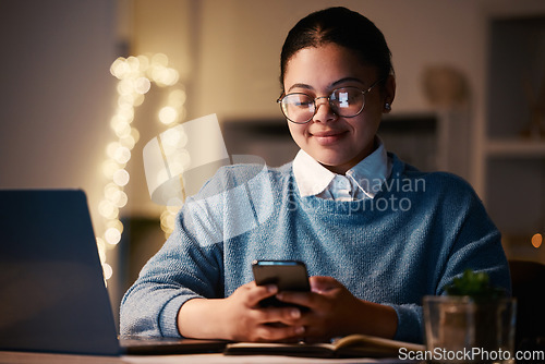 Image of Business woman, phone and typing in home office for web browsing, texting or social media. Night bokeh, cellphone and happy female, freelancer or remote worker with mobile smartphone for research.