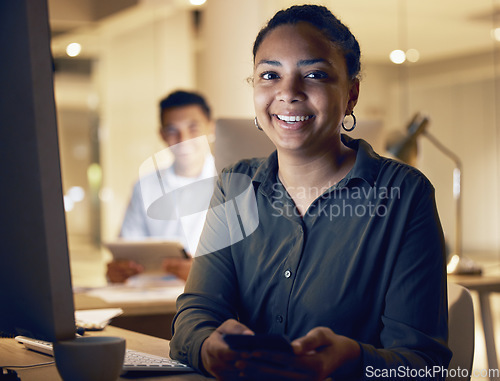 Image of Night, phone and smile with portrait of woman in office for social media, networking and search. Technology, overtime and internet with girl employee at desk for website, contact and online app
