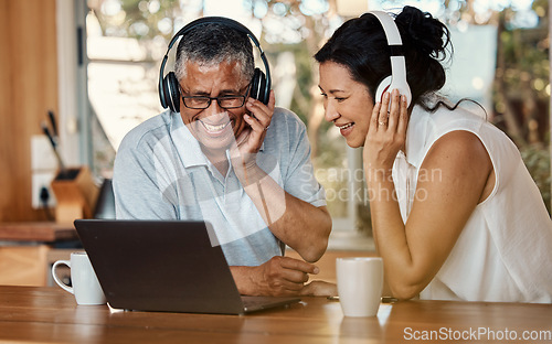 Image of Headphones, laptop and senior couple on video call in home, chatting and talking. Technology, computer and happy, elderly and retired man and woman laughing and streaming a funny online conversation