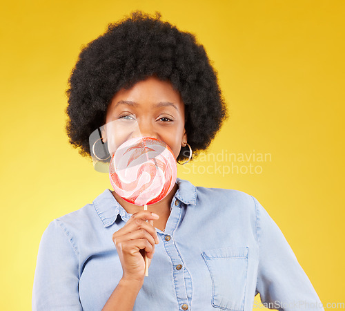 Image of Sweets, candy and lollipop with black woman in studio for colorful, cheerful and positive. Young, happiness and dessert with female isolated on yellow background for treats, food and confectionary