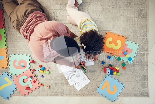 Image of Home, toys and child with father support and helping with homework and coloring for school. Living room carpet, parent care and kid from above with dad and daughter with knowledge development