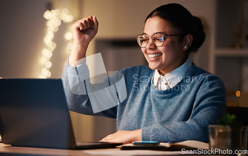 Image of Business, student or success fist for laptop reading in night office on financial software, investment data or growth analytics. Smile, happy or winner woman on technology in working late achievement