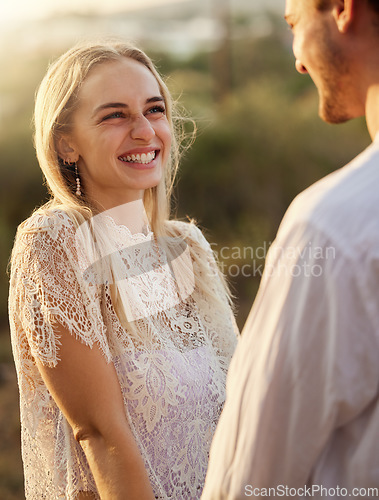 Image of Happy, smile and couple in nature at sunset for romance, bonding and quality time together outdoors. Love, dating and man and woman holding hands on holiday, honeymoon vacation and relax on weekend