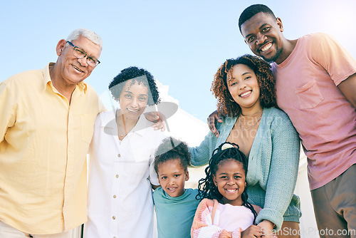 Image of Hug, happy and portrait of an interracial family with a smile, happiness and care on the lawn. Looking, diversity and parents, grandparents and children with love, smiling and bonding in the garden