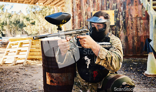 Image of Paintball, target training or man with gun in shooting game playing with on fun battlefield mission. Aim, hero or focused soldier with army weapons gear for survival in outdoor challenge competition