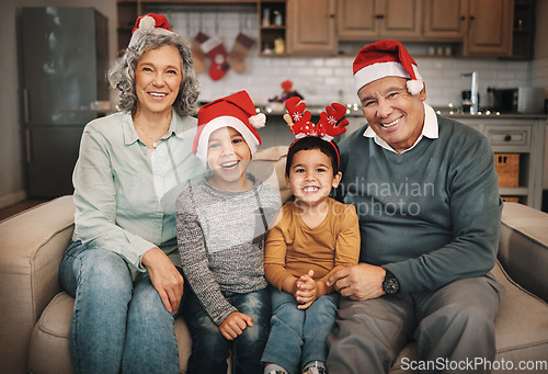 Image of Portrait, christmas and grandparents on the sofa with their grandchildren in the living room as a family. Love, kids or celebration with a senior man, woman and kids together in their lounge