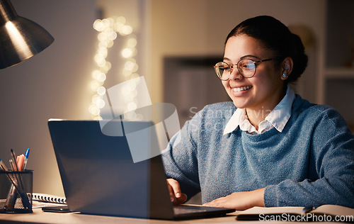 Image of Business, student or laptop in night home office on financial software, investment data or savings growth analytics. Smile, happy or working late woman on technology for finance learning or education