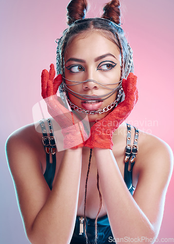 Image of Punk, rock chains and red gloves of a woman with makeup, bondage and bdsm style in a studio. Isolated, pink background and metal aesthetic of a gen z person and hispanic model with rocker clothing