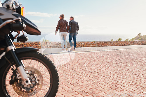 Image of Back, view and a biker couple on a road trip together in summer during retirement. Motorcycle, freedom or travel with a senior man and woman traveling along the coast while bonding on vacation