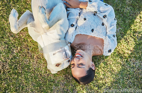 Image of Happy, woman and dog relax on grass with peace and outdoor fun in park, nature and hug pet with love and care. Animal with human bonding top view, Labrador puppy and happiness in countryside.