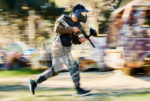 Image of Fast, running and paintball man, gun and outdoor battlefield, playground or games in forest adventure training. Shooting skill, player or sports person with military speed, action and target mission