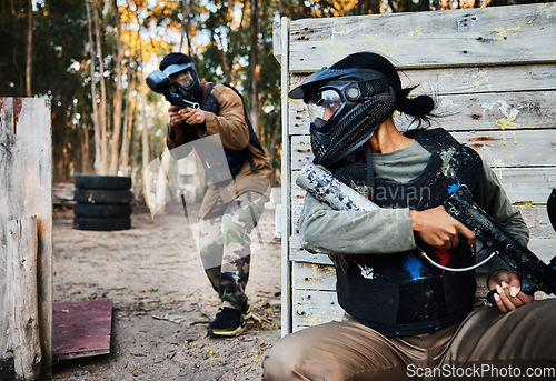 Image of Sports, paintball and woman with gun for battle, game or competition outdoors on field. War fight, military army and female soldier with weapon on shooting range while hiding from player for exercise