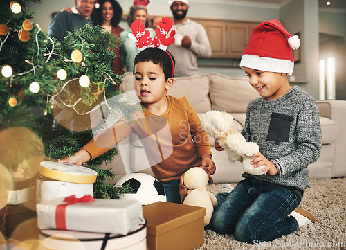 Image of Christmas, happy and children opening gifts, looking at presents and boxes together. Smile, festive and kids ready to open a gift, or present under the tree for celebration of a holiday at home