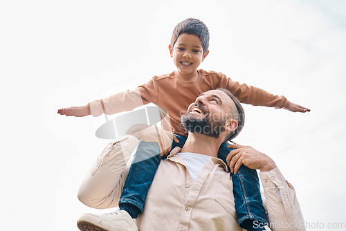 Image of Family, kids and boy sitting on the shoulders of his father outdoor while bonding from below. Fun, children and love with a man carrying his son outside while spending time together being playful