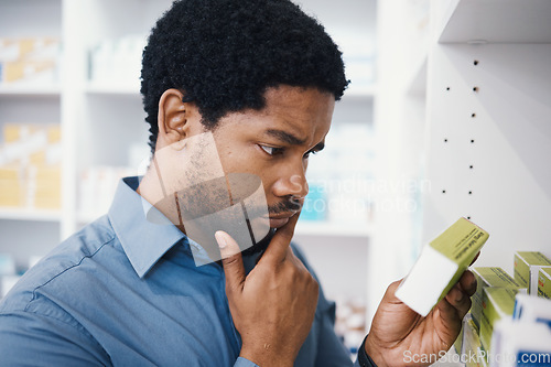 Image of Black man, shopping or box in pharmacy for medicine, reading or pills in retail healthcare in store. African customer, decision or sale for health, deal or thinking for benefits of medical product