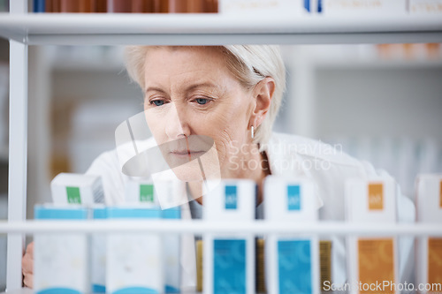 Image of Senior woman, shop stock and pharmacist check shelf in a pharmacy for drug information. Healthcare, wellness and working elderly person with pharmaceutical drugs reading box product ingredients