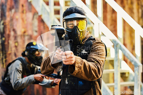 Image of Paintball, person shot with paint and gun, helmet for safety on shooting range and war game for sports. Soldier with weapon on battlefield, action and camouflage uniform with adventure and target