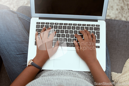 Image of Laptop, woman and hands typing on a keyboard while working on a freelance project at her house. Technology, research and closeup of female working on a report with a computer in living room at home.