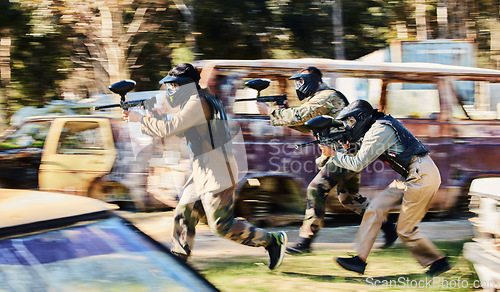 Image of Team, paintball and army moving on the attack in extreme adrenaline sport, battle or war in the nature outdoors. Group of paintballers or soldiers in rush aiming down sights in teamwork engagement