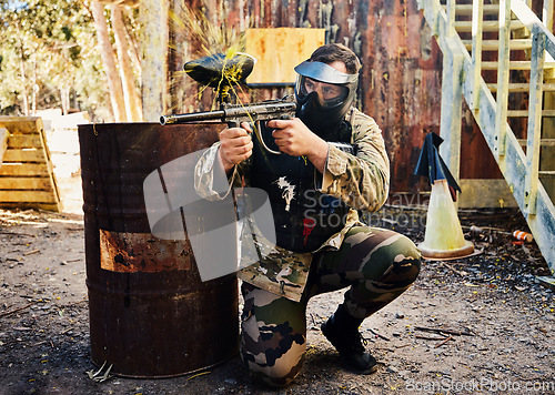 Image of Paintball, target training or male with gun in shooting game playing with on fun battlefield mission. Aim or focused man with army weapons gear for survival in outdoor challenge competition