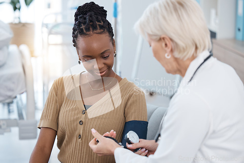 Image of Blood pressure, hypertension and doctor with black woman in hospital of healthcare, consulting and clinic services. Medical worker check patient arm pulse, test and heart wellness of diabetes results