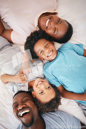 Image of Black family, bedroom portrait and top view with smile, happiness and kids with funny time with dad, mom and love. Happy children, parents and bed for bonding, care and support in morning for holiday