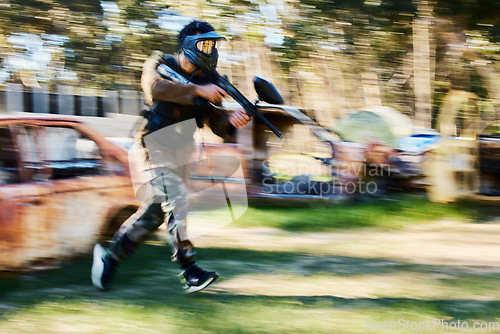 Image of Paintball, blurry action or man running in shooting game with speed or fast motion on fun battlefield. Mission focus, moving or war soldier with gun for survival in competition in nature or forest